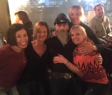 Band member surrounded by fans at a show